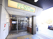 Go outside through the automatic doors to your right. Then head left to find the entrance to the south building of Fesan and descend to the B1 floor.
