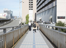 Head down the footbridge, go down the stairs in front of Kaisei Hospital 